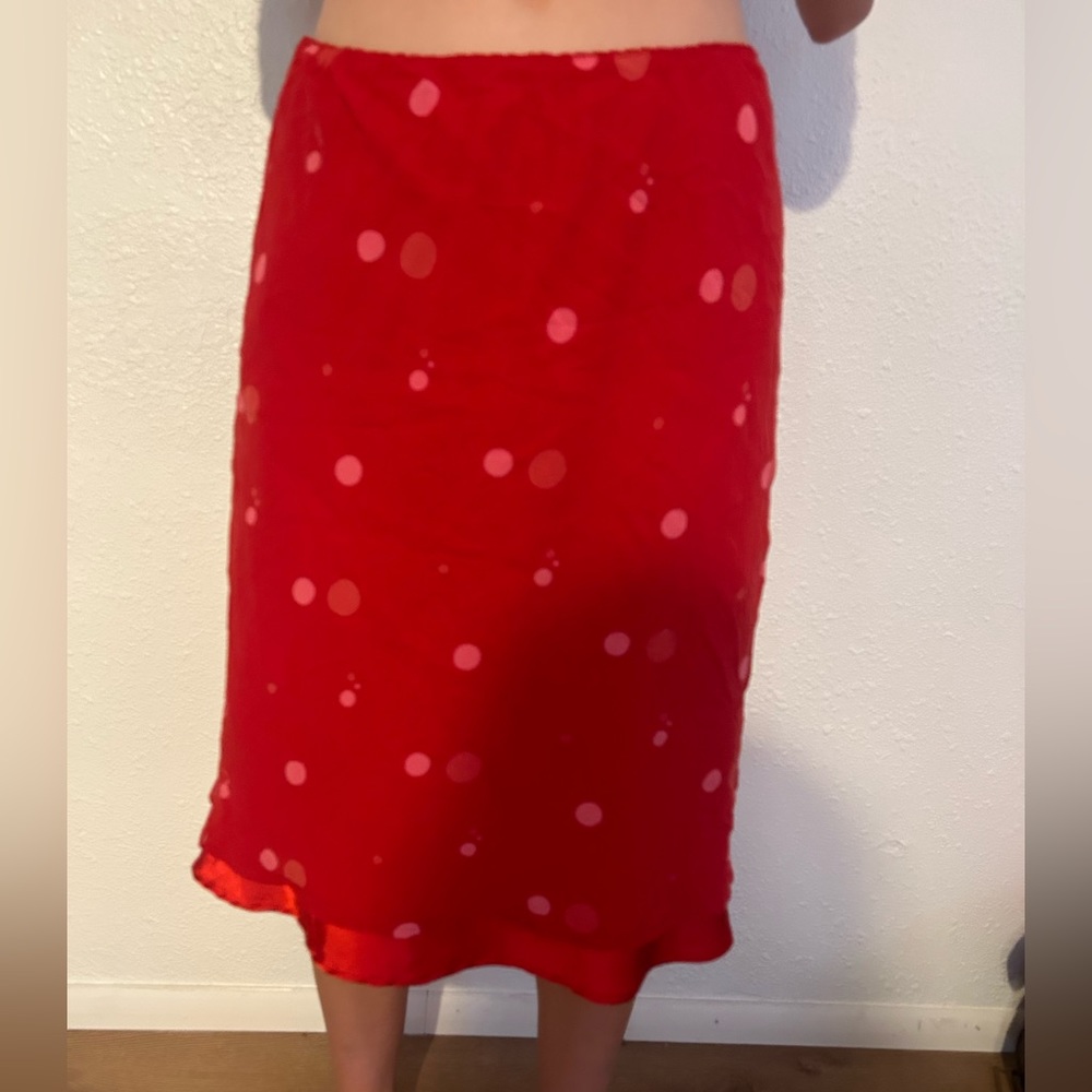 Red maxi skirt with polka dots as a design.